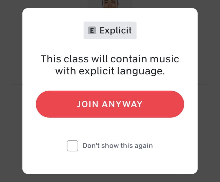 Explicit music pop-up notification on a live Peloton class.