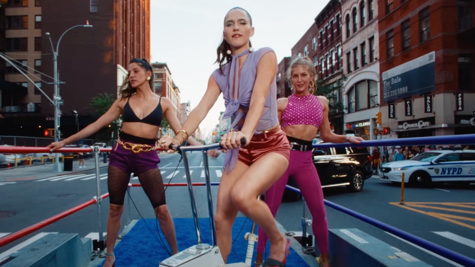 Peloton instructors Hannah Corbin and Rebecca Kennedy in Sofi Tukker's music video for "Woof," alongside Sophie Hawley-Weld