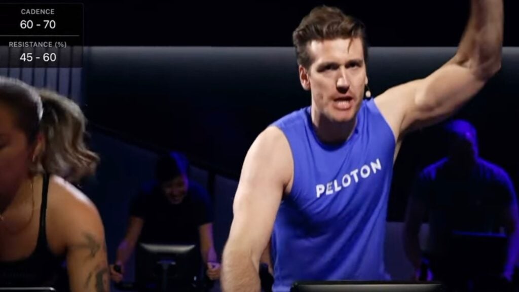 Bradley Rose teaching from member bike in studio.